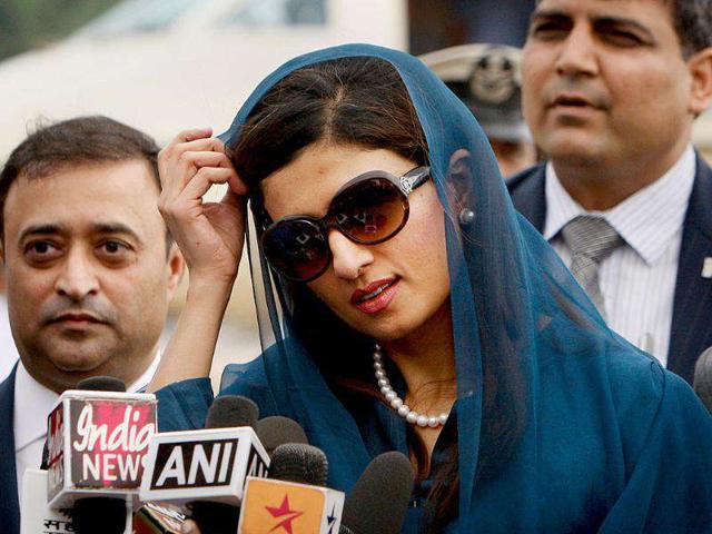Pakistan's newly installed foreign minister Hina Rabbani Khar talks to media upon her arrival at the airport in New Delhi.