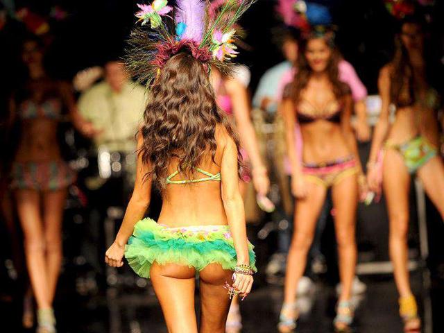 A model flaunts a colourful headgear as she walks the ramp for Leonisa during the Colombiamoda fashion show. (AFP) 