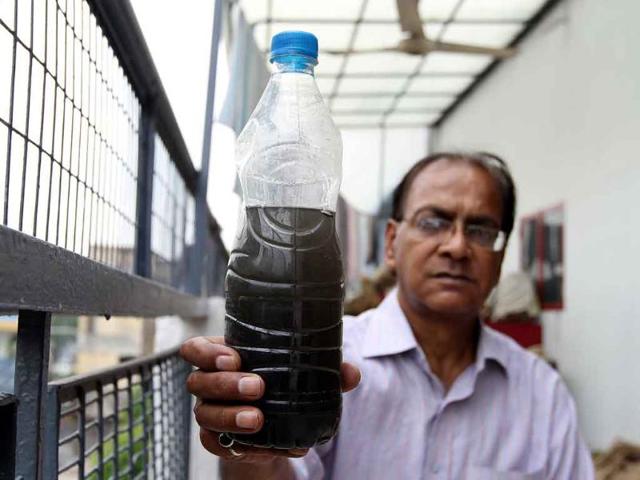 Ajay-Vir-Singh-with-the-water-supplied-to-his-South-Ex-I-home Ajay-Vir-Singh-with-the-water-supplied-to-his-South-Ex-I-home