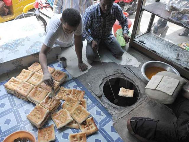 A young Muslim prepares nan bread during the holy month of Ramadan in Hyderabad