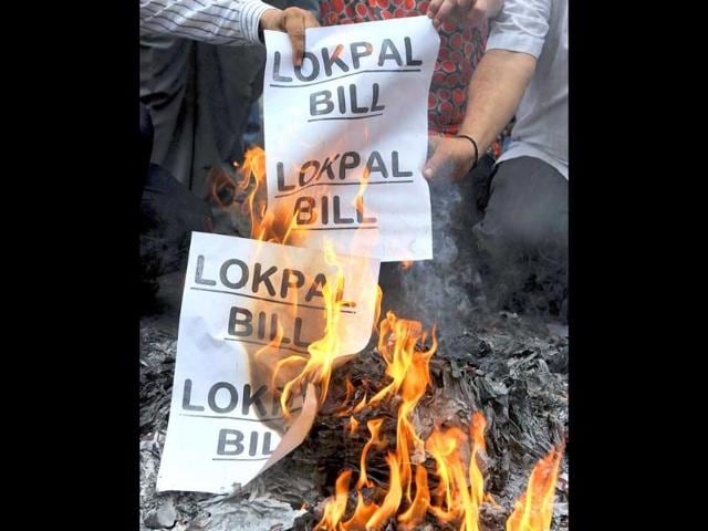 Anti-corruption activists burn symbolic copies of the lokpal bill draft during a protest to denounce the proposal in its current form in Mumbai.