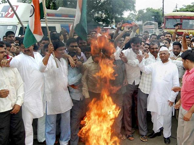 Social activist Anna Hazare along with supporters burning the copies of government version of lokpal bill draft introduced in Parliament for discussion, at Ralegaon Siddhi in Pune.