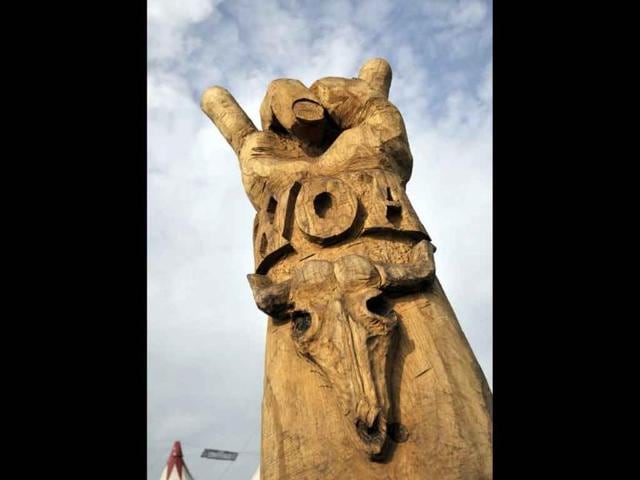A wooden sculpture of a raised arm with the 'W.O.A' (Wacken Open Air) logo is pictured during the annual heavy metal music open-air festival in the northern German village of Wacken, near Hamburg.