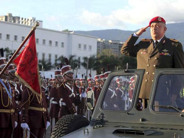Venezuela's President Hugo Chavez salutes from a vehicle as he attends the anniversary ceremony of National Guard in Caracas.