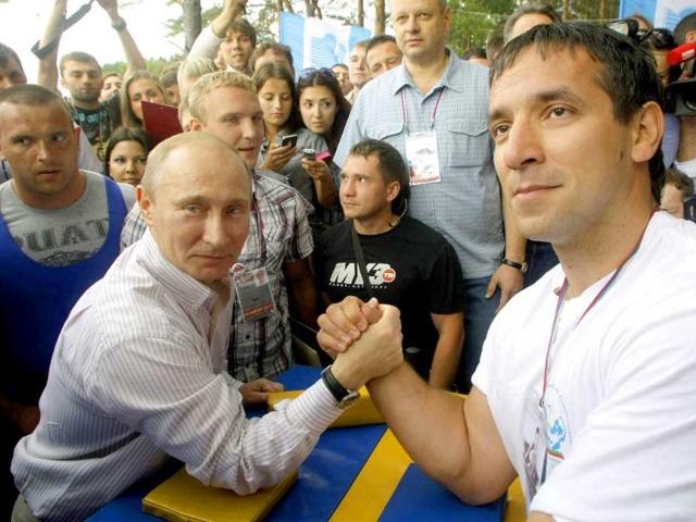 Russian Prime Minister Vladimir Putin prepares to arm wrestle during his visit to the Seliger youth educational forum in the Tver region, Russia.