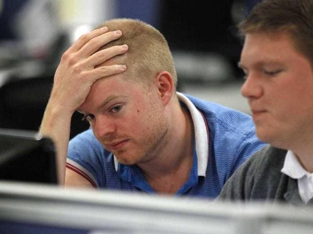Traders work on the dealing floor at IG Index in London. World stocks sank for an eighth straight session on Friday, wiping $2.5 trillion (1.53 trillion pounds) off their value on the week, as concern ballooned over the slowing global economy and the spread of debt anguish into Italy and Spain.