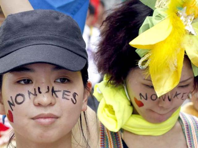 Protesters bearing anti-nuclear face-painting take part in an anti-nuclear march in Hiroshima.