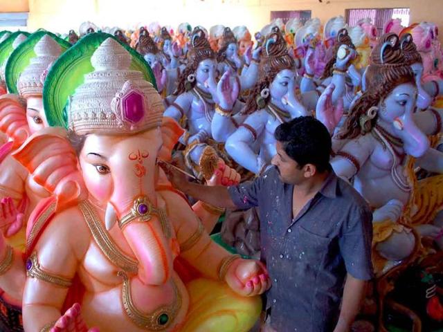 An artist gives finishing touches to the idols of Lord Ganesha ahead of the Ganesh Chathurti festival in Karad, Maharashtra.