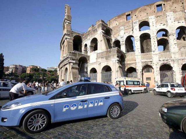 Italian police at the Colosseum in Rome, Italy after tourists were evacuated from the site following an anonymous threat was made by telephone.