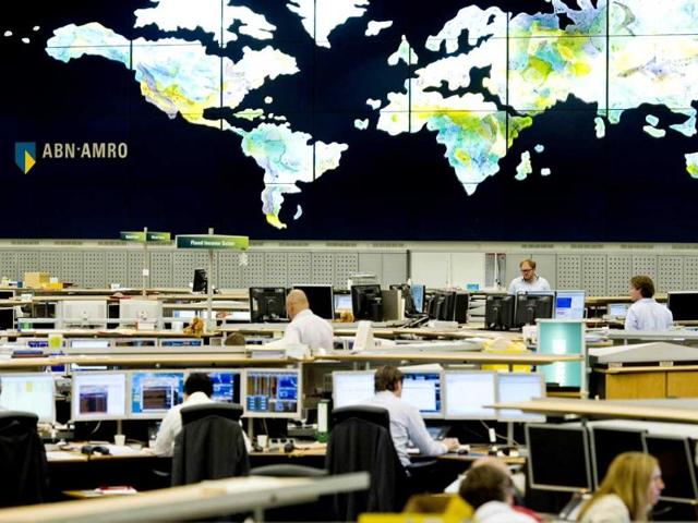 Traders in the dealing room of the ABN AMRO bank in Amsterdam, watch global transactions.
