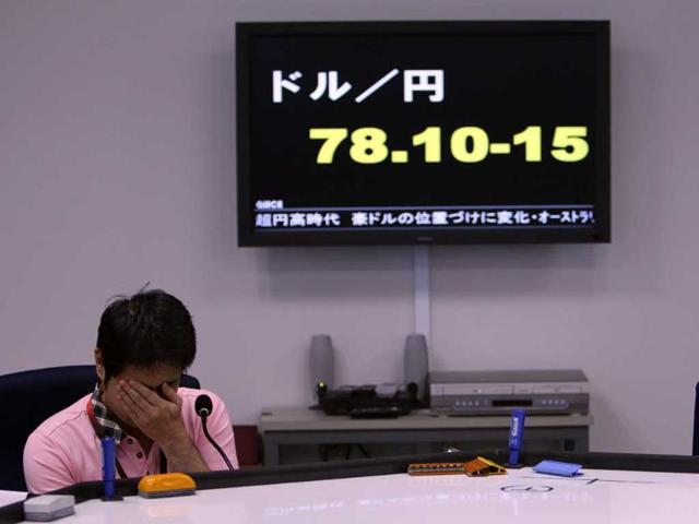 A money trader waits for calls from clients during the morning trading at a money brokerage in Tokyo.