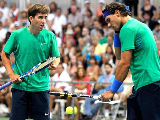 Marc Lopez and Rafael Nadal of Spain confer between points while playing Tomas Berdych of the Czech Republic and Florian Mayer of Germany during the Rogers Cup at Uniprix Stadium in Montreal, Canada.