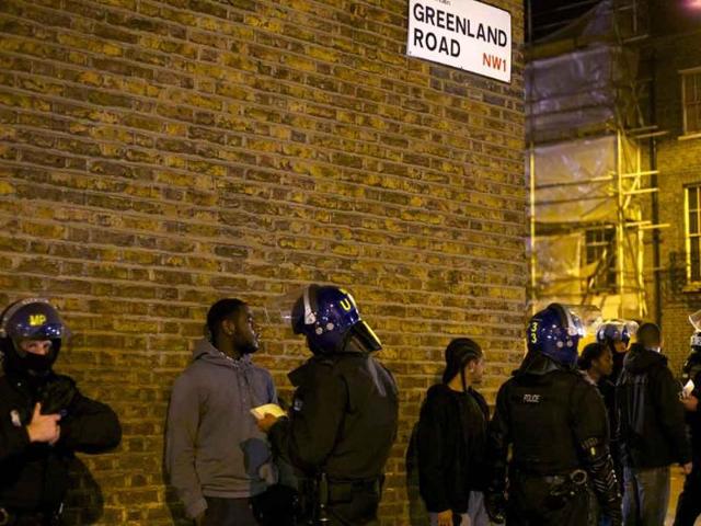 Youths are stopped and searched by British police officers following skirmishes with police in Camden Town, north London. Violence and looting flared across London, and spread to a second major city, as shops and cars were set ablaze and authorities struggled to contain a third night of unrest in Britain's capital, which will host next summer's Olympic Games.