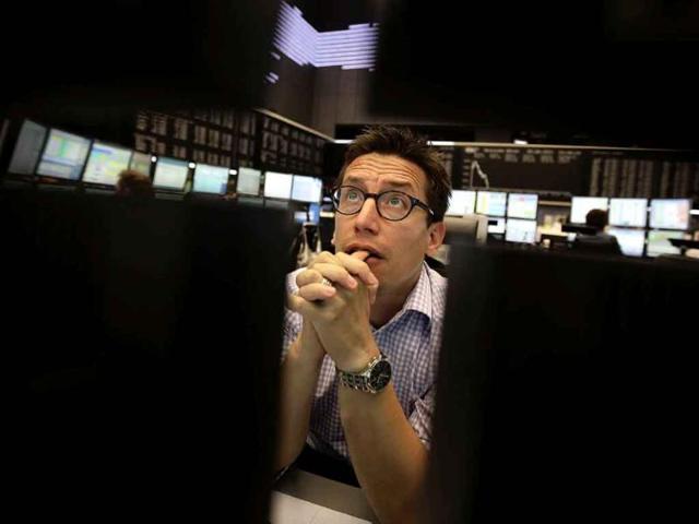 A share trader reacts on early morning trading at Frankfurt's stock exchange1. European stocks pared early gains on Tuesday and slipped back into negative territory, as energy shares sank along with oil prices, eclipsing bargain hunting in recently-hammered mining stocks.