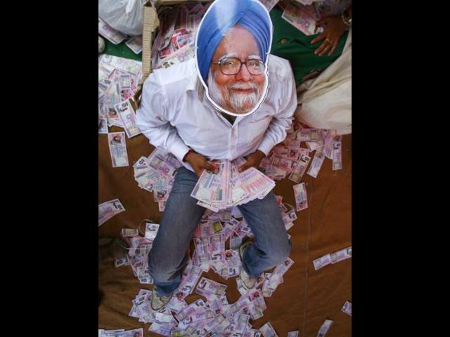 An activist from main opposition Bharatiya Janata Party, wears a mask depicting Prime Minister Manmohan Singh, during an anti-government protest in New Delhi.