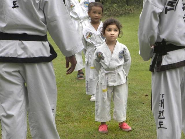 A young girl listens to instructions from her Taekwondo instructor during a practice session, in New Delhi. A young girl listens to instructions from her Taekwondo instructor during a practice session, in New Delhi.