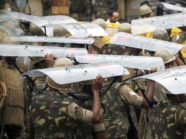 Police use their shields to cover themselves from a downpour during an anti-government protest organised by Bharatiya Janata Party (BJP) in New Delhi. Demonstrators marched on parliament demanding the resignation of Delhi chief minister Sheila Dikshit over corruption, according to local media.