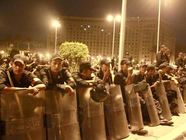 Security forces stand guard in central Tahrir square to prevent protesters from camping out in Cairo. More than 42 political parties and youth coalitions gathered in the square, the focal point of the uprising that toppled former president Hosni Mubarak, to break their fast after activists called for a million-man protest to demand a civilian state.