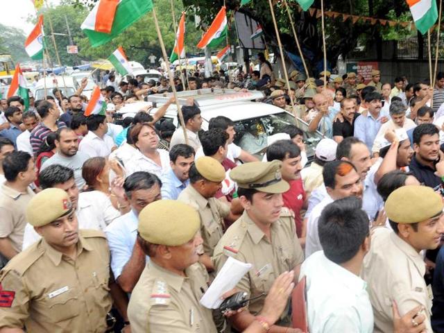 Supporters of social activist Anna Hazare surround a police vehicle in New Delhi which is carrying the activist after his arrest by police authorities.