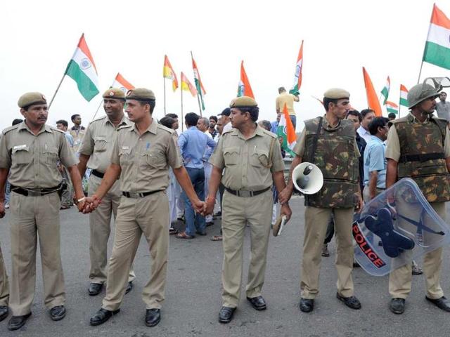 Police personnel cordon off supporters of social activist Anna Hazare after his arrest in New Delhi.