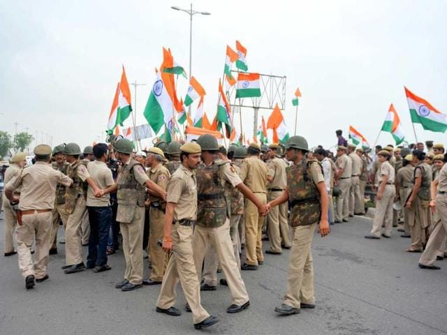 Policemen control supporters of Anna Hazare, after his arrest, in New Delhi.