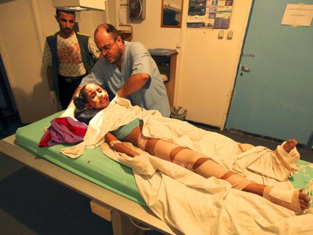 A Palestinian doctor tends to an injured girl at Al-Shifa hospital, after an overnight Israeli air strike, in Gaza City.