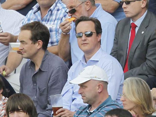 British Prime Minister David Cameron watches the action between England and India on the second day of the fourth test match between England and India at The Oval Cricket Ground in London.