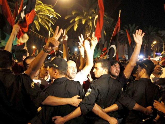 Members of the Libyan community in Tunisia gather outside the Libyan Embassy in Tunis.