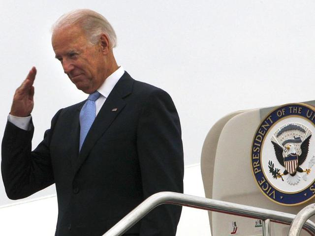 US vice president Joe Biden salutes to a send off party before boarding Air Force Two to depart for Mongolia from the airport in Chengdu, China.