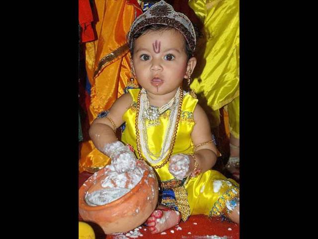 A kid dressed as Lord Krishna takes part in a competition on the occasion of Janmashtami in Guwahati.