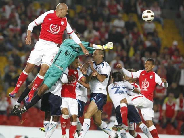 German Centurion (L) of Colombia's Independiente Santa Fe heads the ball during a Copa Sudamericana soccer game against Peru's University Cesar Vallejo in Bogota, Colombia.