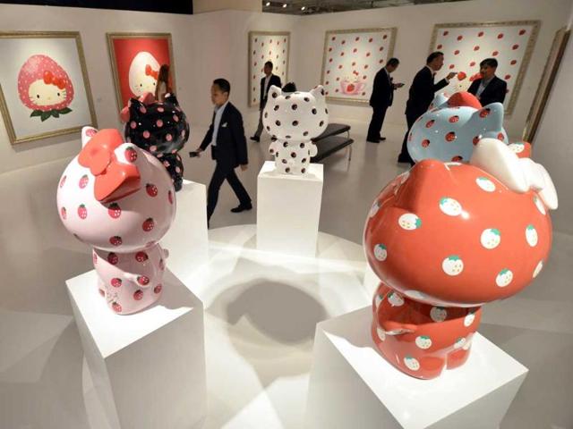 Vistors look at paintings and statues of Hello Kitty, designed by Hello Kitty creator Yuko Yamaguchi at a preview of a Hello Kitty Art Exhibition in Tokyo.