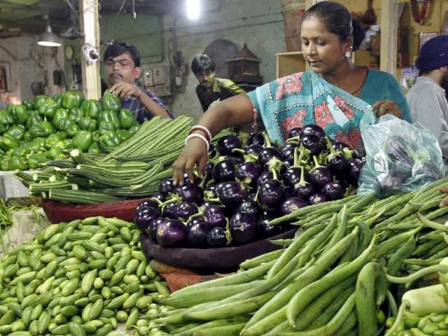 Customers buy vegetables at a market in the Ahmedabad. India's food price index rose 9.80% in the year to August 13, government data on Thursday showed.