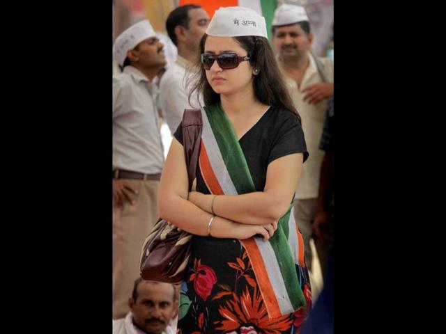 A supporter of anti-corruption activist Anna Hazare waits for Hazare to come on stage on the 10th day of his hunger strike in New Delhi.