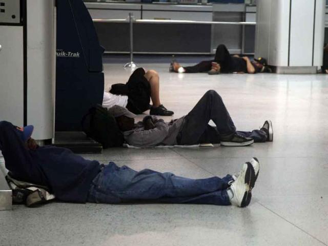 People sleep at Penn Station in New York, as Hurricane Irene approaches the region.