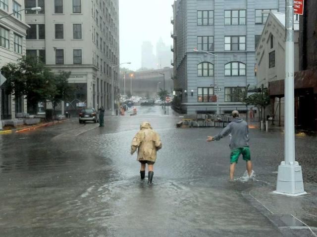 Nancy Zakhary and Eddie Lima of Brooklyn wade through flood waters filling the intersection of Main St and Plymouth St in Dumbo Brooklyn as Hurricane Irene reaches the New York City Area.