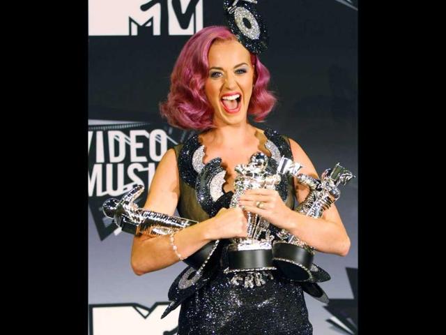 Singer Katy Perry holds her three awards, Video of the Year for Firework, Best Collaboration,and Best Special Effects which she won at the 2011 MTV Video Music Awards in Los Angeles.