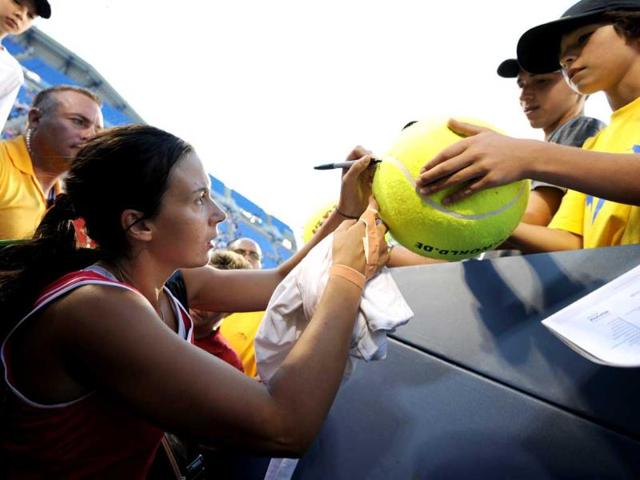 Marion Bartoli of France signs autographs after defeating Alexandra Panova of Russia, 7-6, 6-3, during the US Open tennis tournament at the Billie Jean King National Tennis Center in New York.