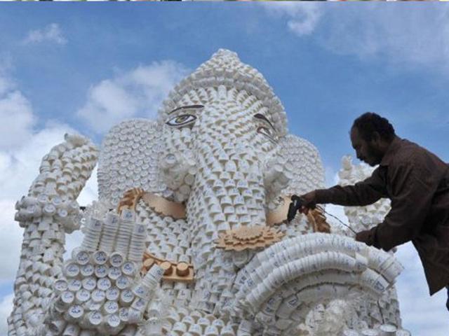 An artist works on a Ganesh idol made out of 30,000 paper cups in Hyderabad