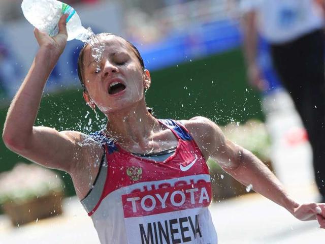 Tatiana Mineeva refreshes herself while taking part in the Women's 20km walk at the IAAF World Championships.