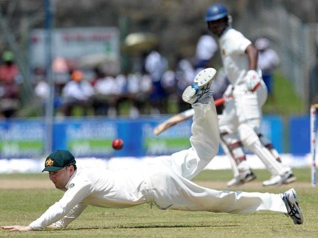 Australian cricket team captain Michael Clarke dives as he attempts to field a ball hit by Sri Lankan batsman Tharanga Paranavitana during the second day of the opening Test cricket match between Australia and Sri Lanka at the Galle International Stadium in Galle.