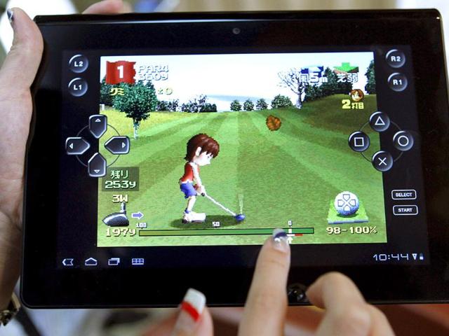 A models plays a game on Sony's new tablet computer Tablet S during a launch event in Tokyo.