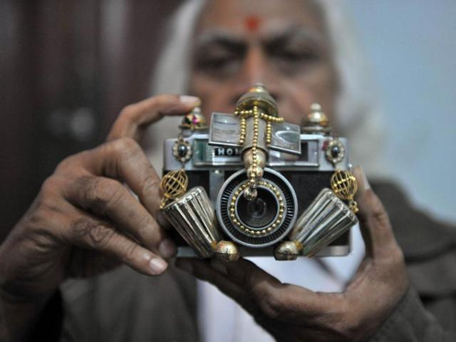 Doctor Amaravadi Prabhakar Chary shows an idol of Lord Ganesh in the form of a camera as showcased at an exhibition in Hyderabad on the ocassion of Ganesh Chaturthi.
