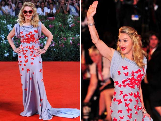 Madonna arrives for the screening of W.E. at Venice Lido, wearing a grey dress with embossed red butterflies and sunglasses! W.E. is director Madonna's out of competition presentation at the festival.