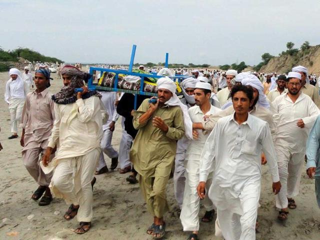 Pakistani relatives and local residents carry the body of a blast victim during a funeral ceremony following a suicide bomb attack near a police station in the Lakki Marwat district of Khyber Pakhtunkhwa province.