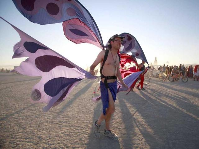 Scott Zimmerman wears wings during the Burning Man 2011 "Rites of Passage" arts and music festival in the Black Rock desert. More than 50,000 people from all over the world have gathered at the sold out festival which is celebrating its 25th year.