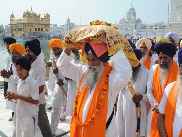 Sikh head priest of Sri Akal Takhat Sahib, Gurbachan Singh (C), carries the Guru Granth Sahib, the holy book of the Sikh religion, during a march to mark the 350th birth anniversary of the Sikh warrior Shaheed Baba Jiwan Singh, at the Golden temple in Amritsar. The Sikh's celebrate Shaheed Baba Jiwan Singh who was a famous warrior from the Sikh religion during the 17th century.