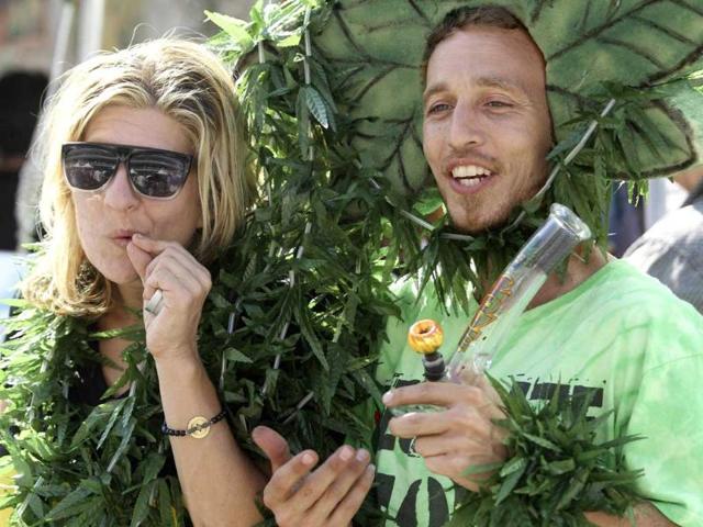 Attendees Melissa Balin (L) and Magic J. Ellingson play to a video camera at the International Cannabis Hemp Expo in Oakland, California.