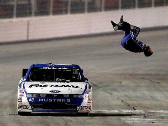 Carl Edwards, driver of the #60 Fastenal Ford, celebrates with a backflip after winning the NASCAR Nationwide Series Great Clips 300 at Atlanta Motor Speedway on September 3, 2011 in Hampton, Georgia.