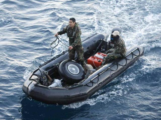 Members of the Chilean navy transport the landing gear of a crashed plane near Juan Fernandez islands about 420 miles (676 km) off Chile's coast. All 21 people aboard a military aircraft that crashed into the Pacific Ocean off the remote Juan Fernandez islands perished.